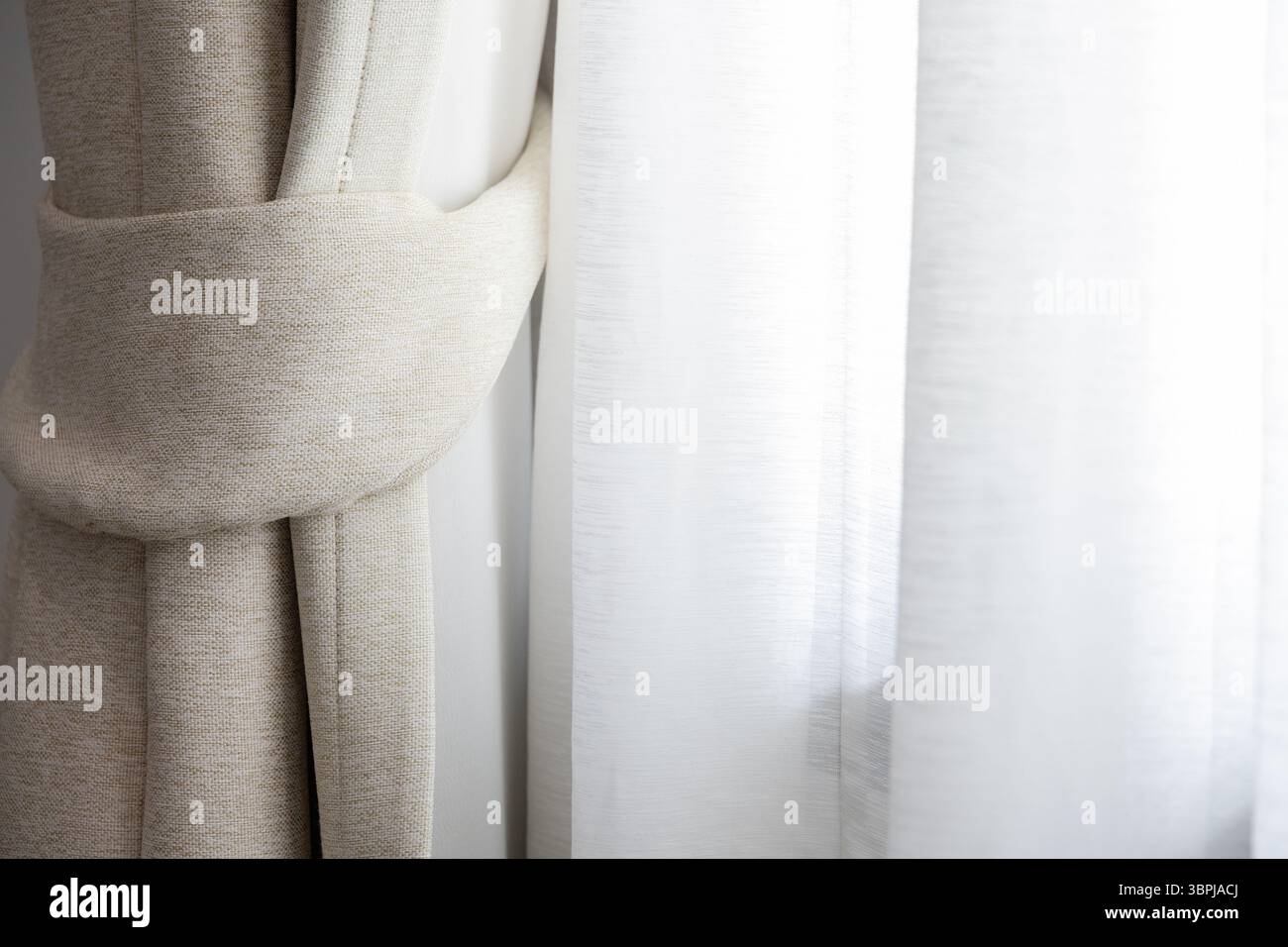Innendesign stilvolle Vorhänge Stoff Fenster hell gemütlich weiches Ambiente warm elegant heitere Wohnkultur weiche Schatten Stockfoto