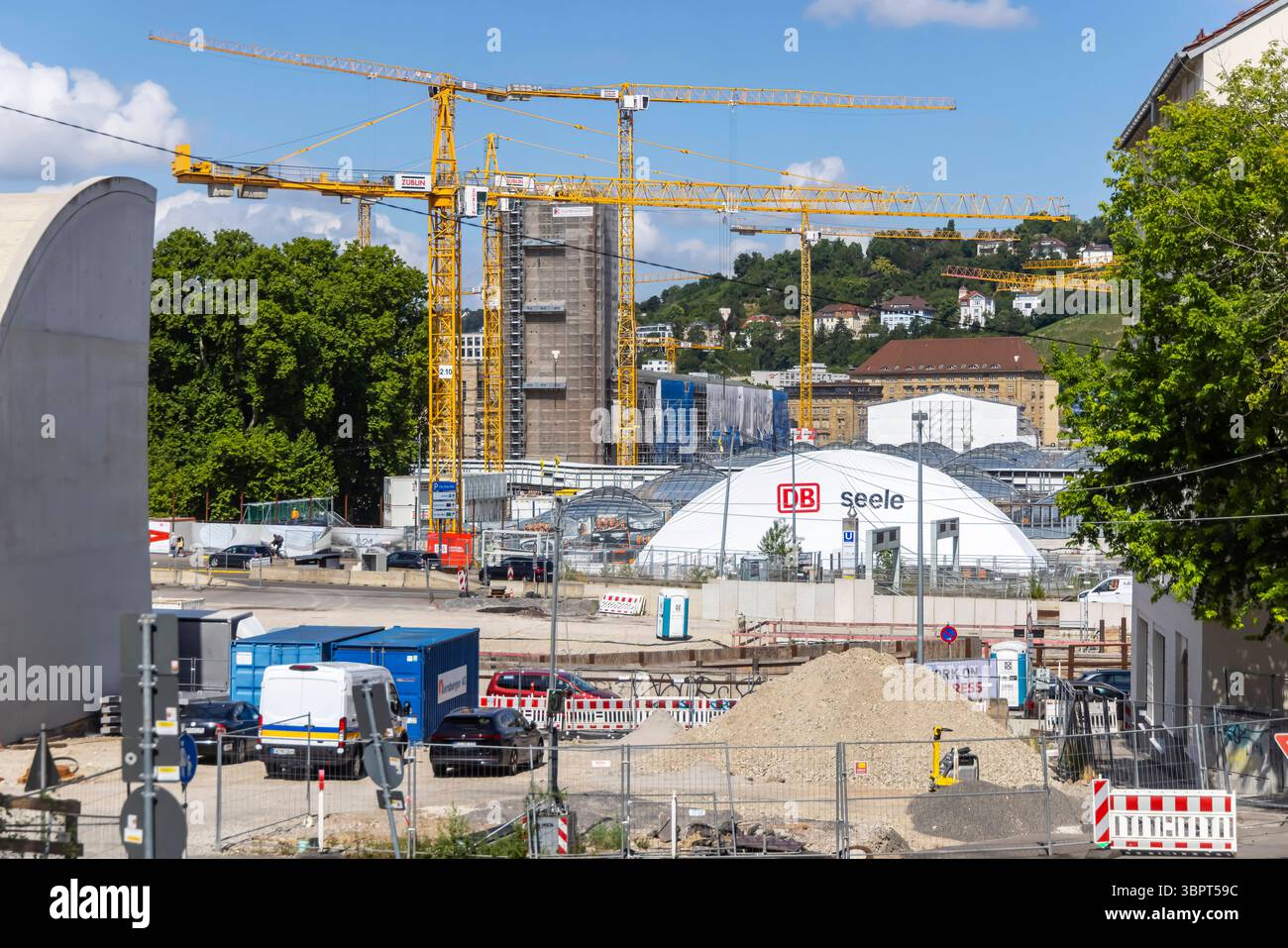 Gitterschale am neuen Durchgangsbahnhof. Eines der künftigen Eingangsportale zum künftigen neuen Hauptbahnhof im südöstlicehn Bereich. Noch ist die neue Stahl-Glas-Konstruktion ist eine Plane abgedeckt. Stuttgart 21. Links das Schwallbauwerk Süd. // 09.07.2025. Stuttgart, Baden-Württemberg, Deutschland *** Gitterhülle am neuen Durchgangsbahnhof eines der zukünftigen Eingangsportale zum künftigen neuen Hauptbahnhof im südöstlichen Bereich die neue Stahl- und Glaskonstruktion wird noch von einer Plane abgedeckt Stuttgart 21 verließ die Südschwellung 09 07 2025 Stuttgart, Baden Württemberg, Keim Stockfoto