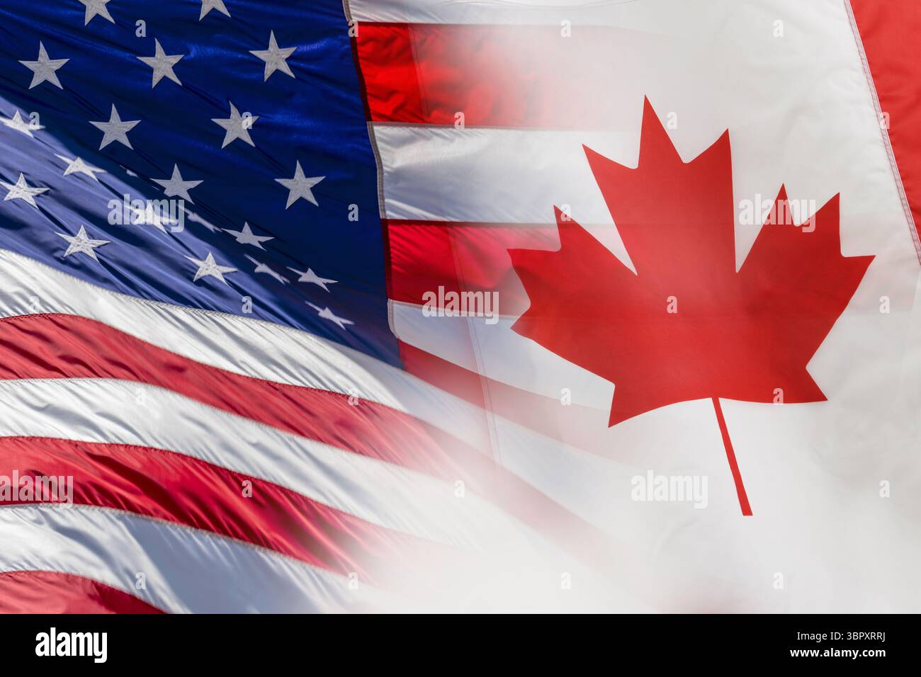 Amerikanische und kanadische Flaggen übereinander Stockfoto