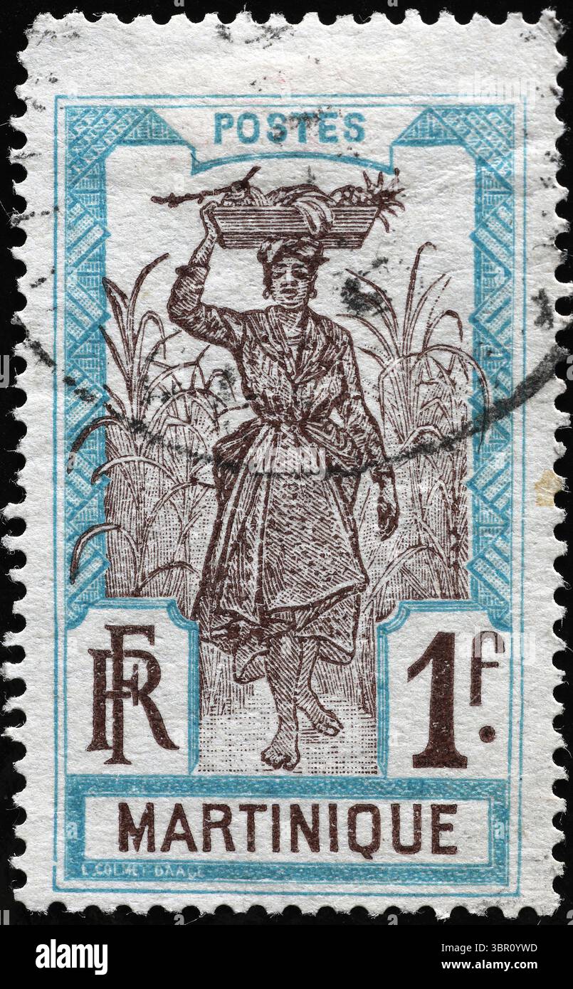 Eine Frau, die Früchte auf der Briefmarke von Martinique trägt Stockfoto