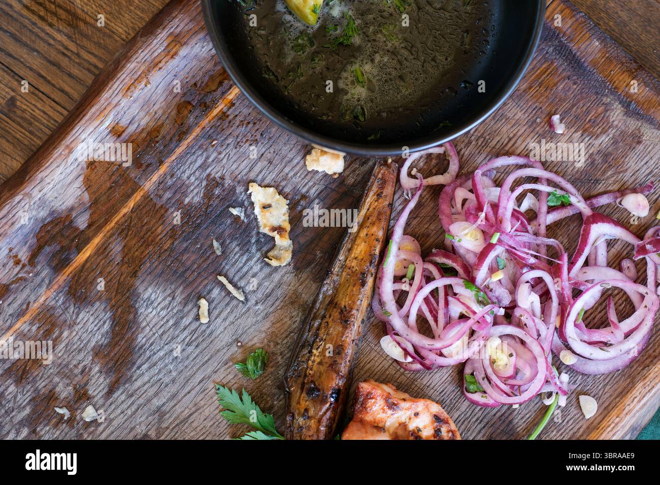 Genießen Sie die Aromen von gegrillten Meeresfrüchten und frischem Gemüse auf einem Holzbrett. Stockfoto