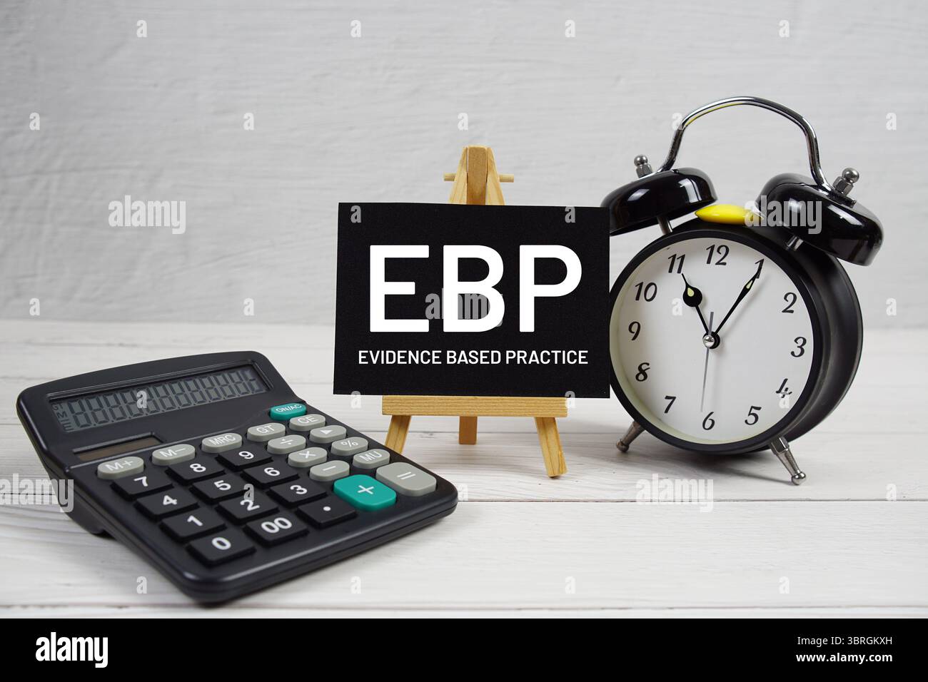 EBP-Evidenz-basierter Übungstext mit Wecker auf hölzernem Hintergrund Stockfoto