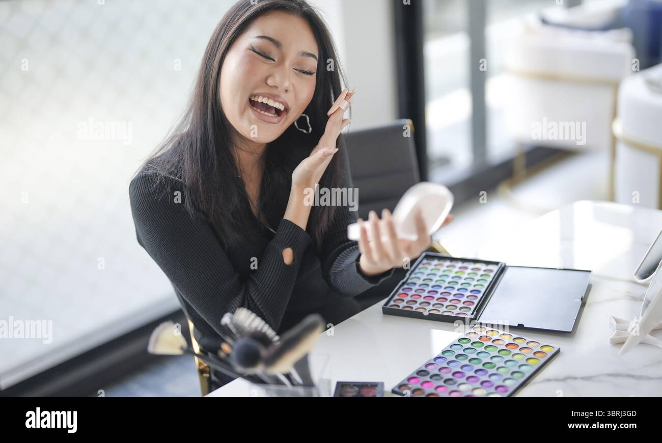 Beauty Influencer asiatische Mädchen Make-up Künstlerin empfiehlt Foundation Kosmetik. Frau Blogger Vlogger Video Beauty Influencer asiatische Mädchen Video online märz Stockfoto