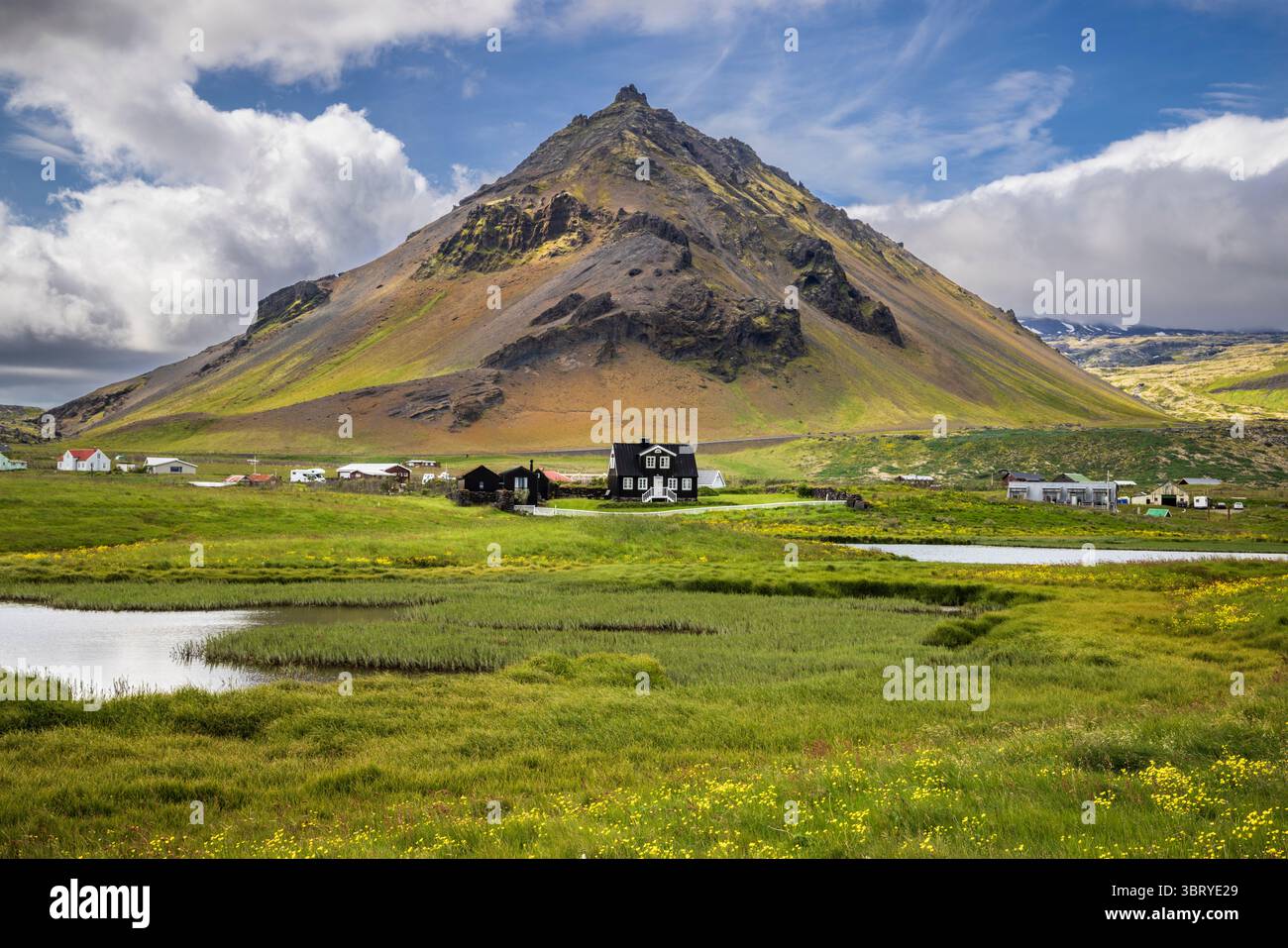 Arnarstapi Dorf mit Stapafell Vulkanberg im Hintergrund, Westisland Stockfoto