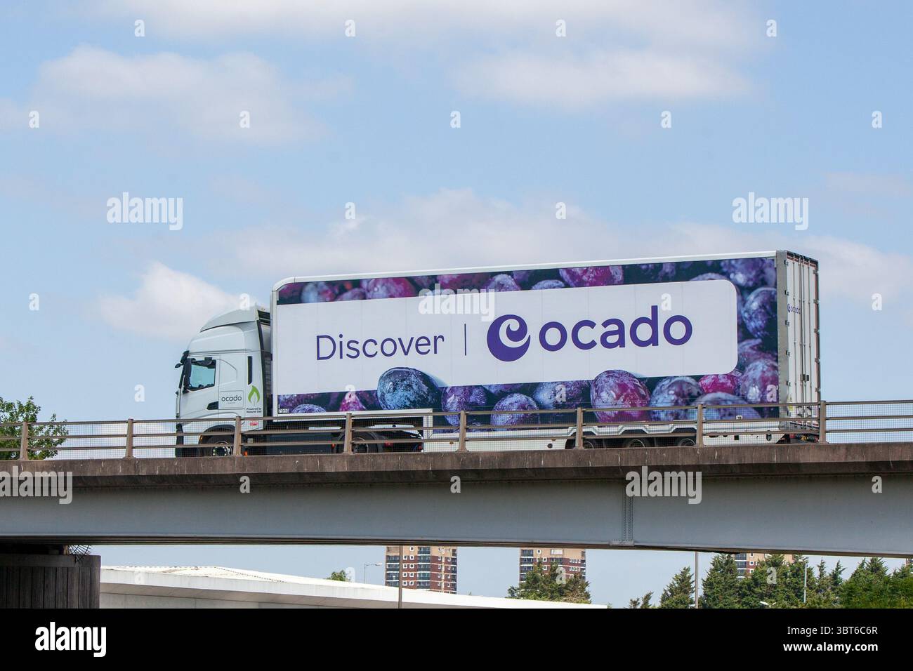 Ein Ocado-Sattelzugwagen mit lebendiger „Discover Ocado“-Lackierung, angetrieben von LNG. Transport von Lebensmitteln auf der Umgehungsstraße A5 in Tamworth, Großbritannien. Stockfoto
