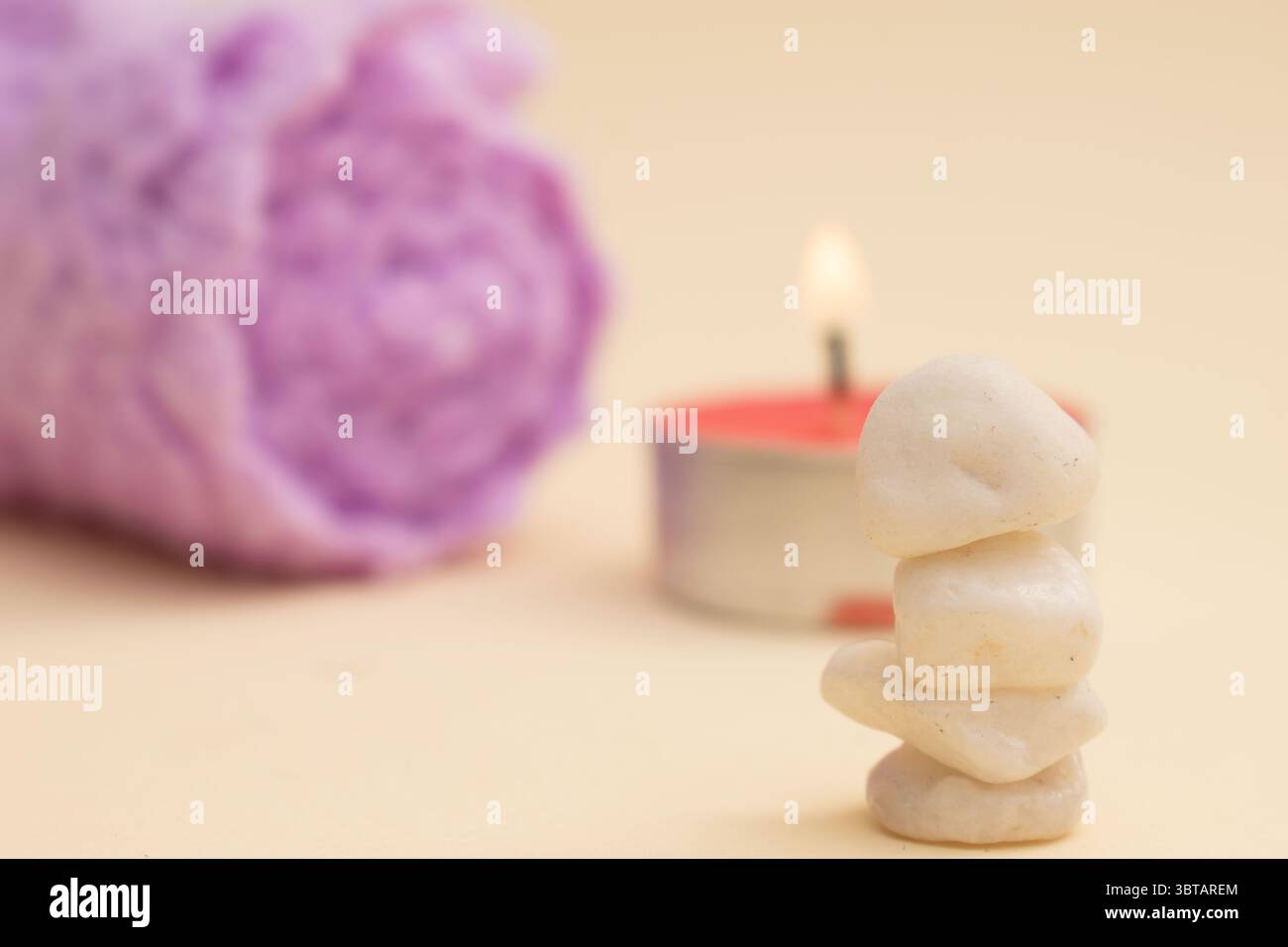 Zen-Steine und Kerzen mit sanftem Licht – Spa- und Meditationskonzept“ Stockfoto