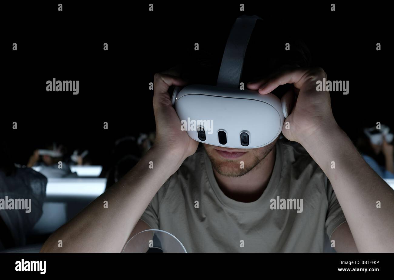 Mann mit Virtual-Reality-Headset in einem dunklen Raum Stockfoto