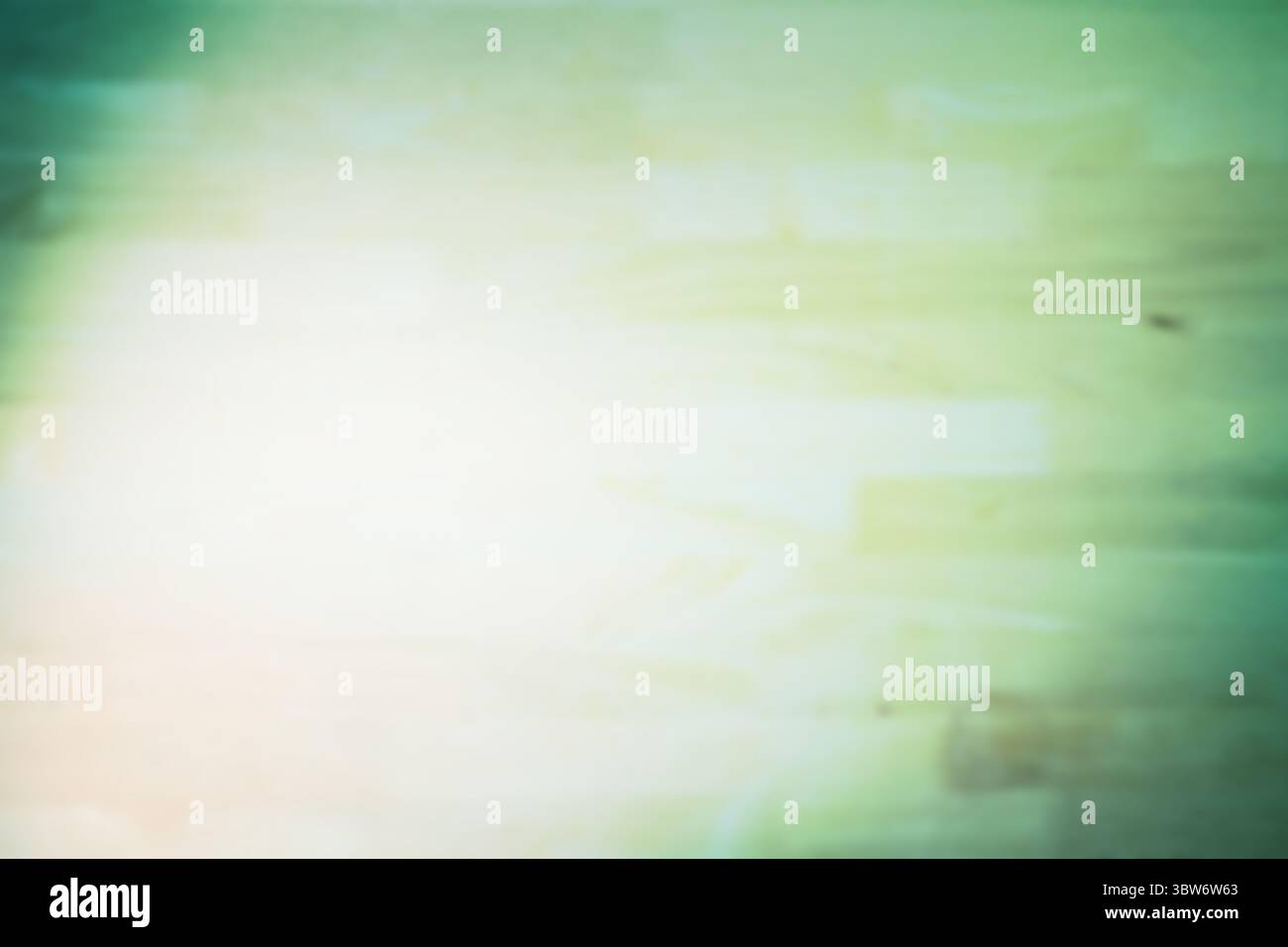 Abstraktes Lichtleck verteilt sich über flachen Design-Hintergrund mit pastellgrüner Holzstruktur Stockfoto