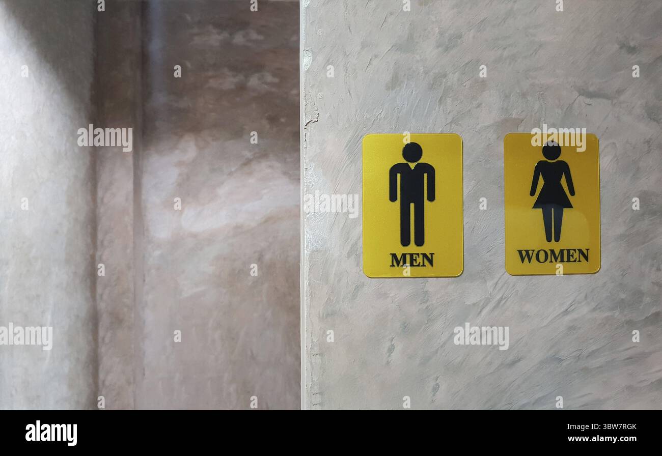 Öffentliche Toilette für Männer und Frauen. Zeichen für die Dame und den Herrn Waschraum wc genannt. Mixed Gender symbol Wc und Toilette hinter Beton Wand schmücken b Stockfoto