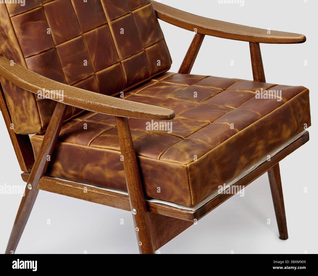 Hochwertige gepolsterte weiche Kissen aus fein genähten Patinierungen aus braunem, patiniertem Leder, die den Holzstuhl im Vintage-Stil, „Tiern“, ergänzen Stockfoto