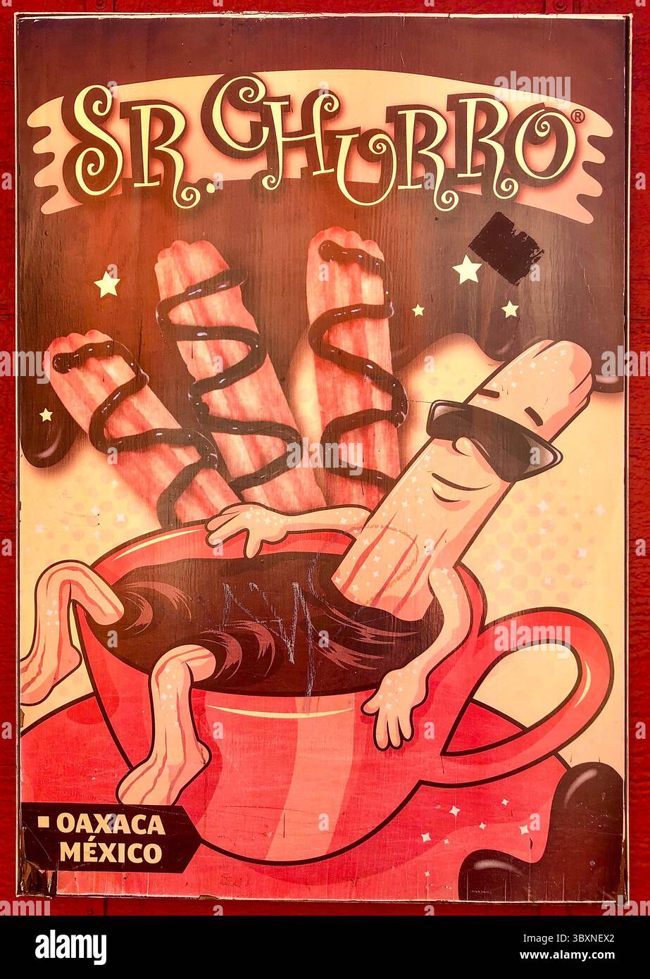 Das skurrile Zeichen in Mexiko zeigt einen lächelnden Churro-Charakter, der sich in einer Tasse heißer Schokolade entspannt – süß, albern und absolut unwiderstehlich! Stockfoto