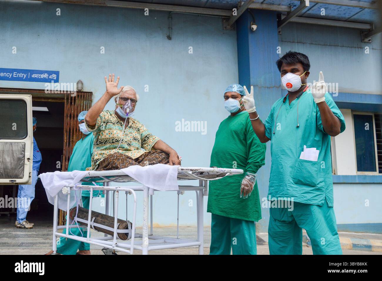 April 2021, Kalkutta, Westbengalen, Indien: Ein Patient, der positiv auf COVID-19-Wellen getestet wurde, da ein Gesundheitspersonal ein Siegeszeichen zeigt, bedeutet, dass sich der Gesundheitszustand dieses Patienten verbessert , in einem Krankenhaus in Kalkutta , Indien , am 23. April 2021 . Ein Patient , der positiv auf COVID-19 getestet wurde , wird am 23 . April 2021 in eine Intensivstation eines Krankenhauses in Kalkutta , Indien , gebracht . Indien brach am zweiten Tag in Folge den Rekord, an dem die höchste tägliche Fallzahl von COVID-19 weltweit verzeichnet wurde. Die tägliche Fallzählung überschritt über 3,3 Lakh-Fälle und über 2000 Todesfälle gestern wie durch einen Indianer Stockfoto