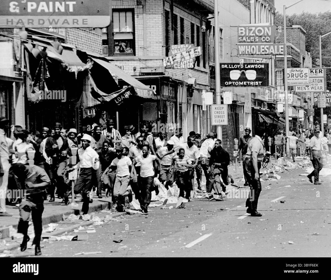 23. Juli 1967, Detroit, Michigan, USA: Die Straßen von Detroit während der Unruhen 1967. Der Aufstand in Detroit 1967, auch bekannt als 12th Street Riot, war eine gewalttätige öffentliche Unordnung, die sich zu einer zivilen Unruhe in Detroit entwickelte. Sie begann in den frühen Morgenstunden des Sonntags, dem 23. Juli 1967. Das Ereignis war eine Polizeirazzia auf eine nicht lizenzierte Bar außerhalb der Geschäftszeiten, die damals als Blindschwein bekannt war, nördlich der Ecke 12th Street (heute Rosa Parks Boulevard) und Clairmount Avenue auf der nahe West Side der Stadt. Polizeikonfrontationen mit Gönnern und Beobachtern auf der Straße entwickelten sich zu einem der Toten Stockfoto