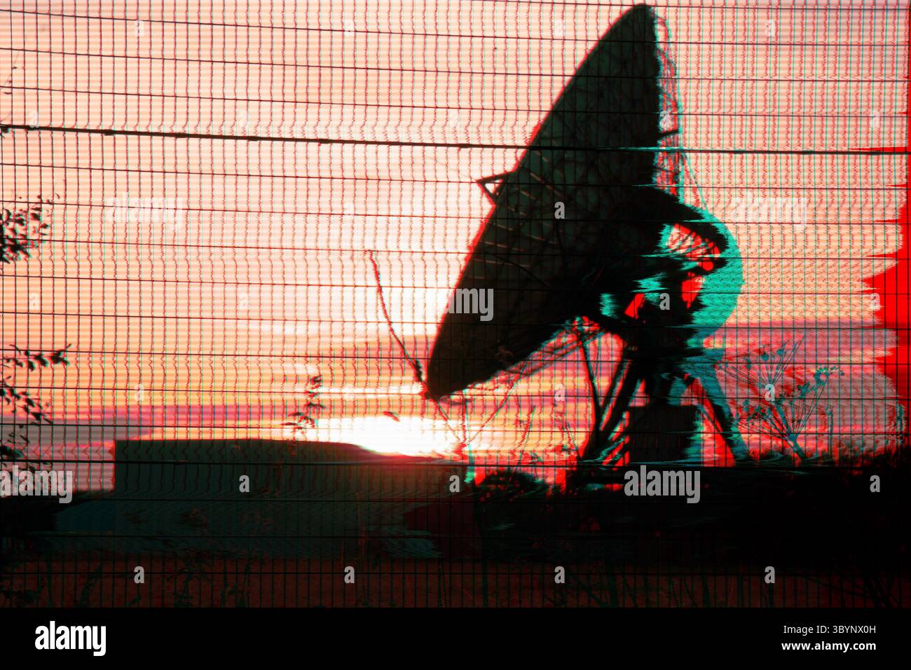 Dish Receiver für Satellitenkommunikation, die von einem Sonnenuntergang umrahmt wird. Mit einem verzerrten dystopischen Infrarotschnitt Stockfoto