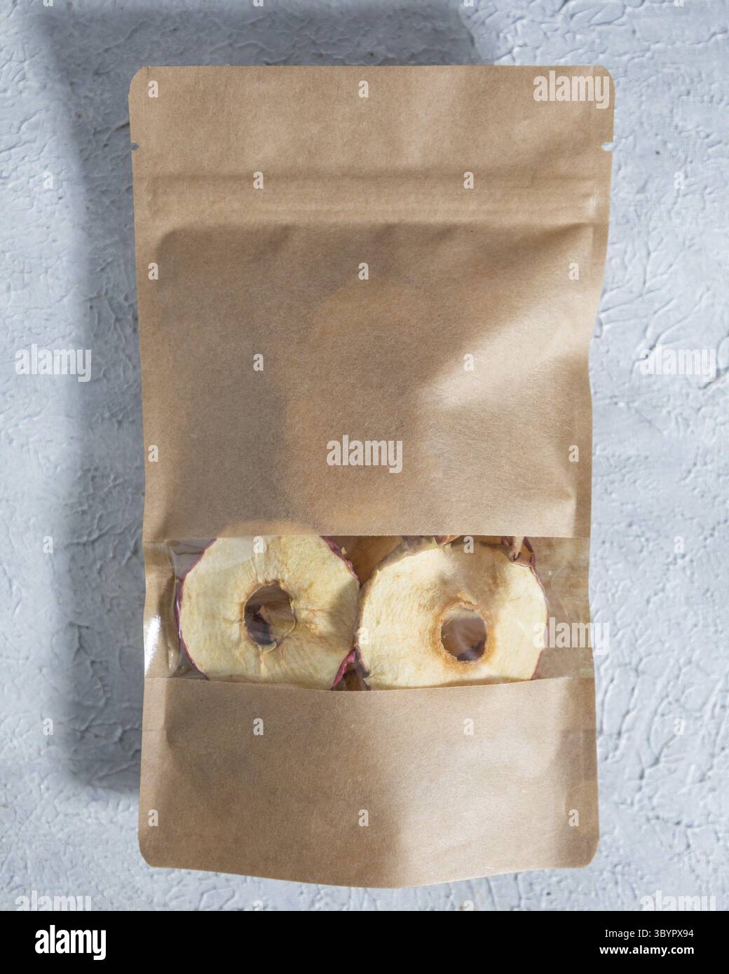 Getrockneter Apfel in Papierverpackung Stockfoto