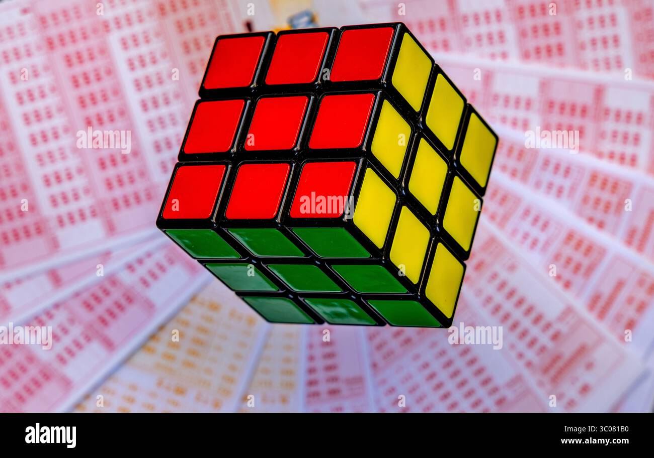 Glücksspiele, bunte Würfel, die über Lottoscheine in die Luft geworfen werden, sucht nach Zahlenspielen und Lotterien Stockfoto