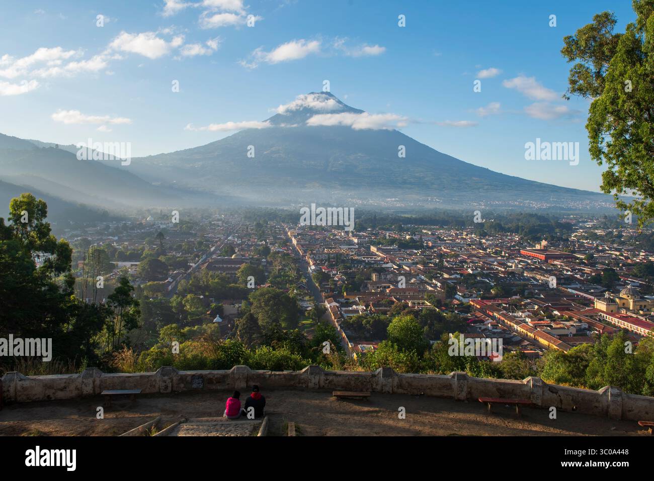 Ein Paar, das auf einem Panoramapunkt über der Stadt sitzt Stockfoto