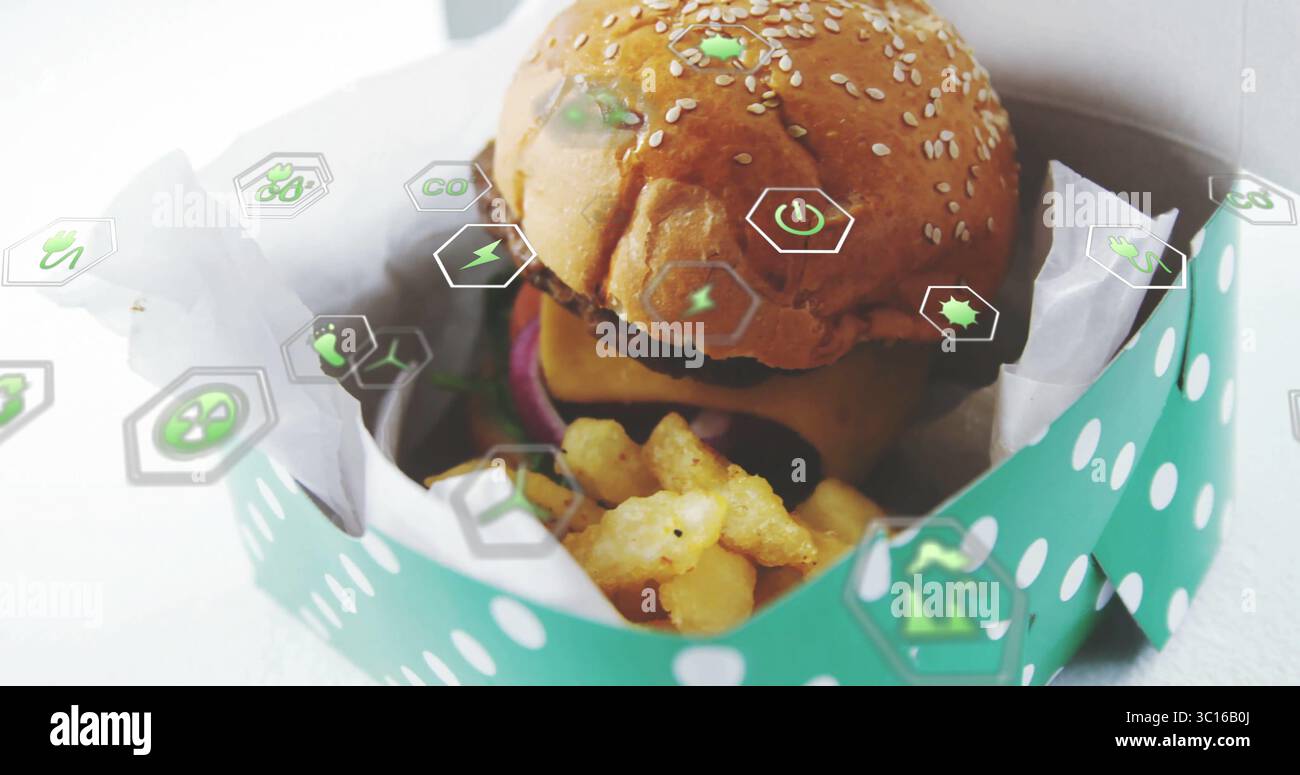 Zeigt Sesamburger mit Zwiebeln und Pommes Frites in To-Go-Box auf der Tischplatte mit digitalen Symbolen Stockfoto
