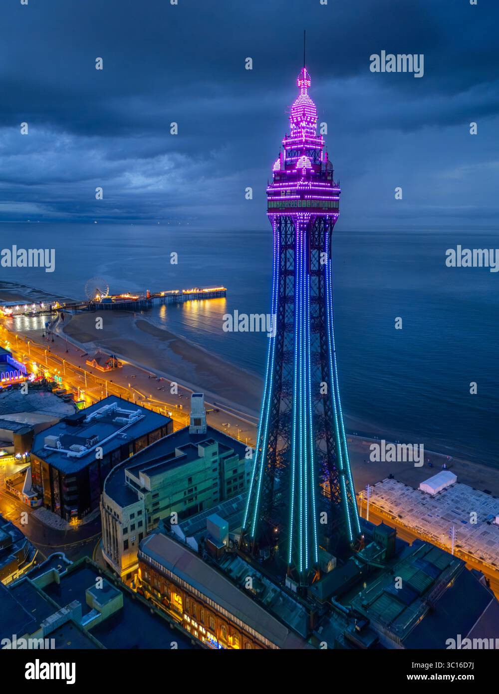 Hochwertiges Luftbild des Blackpool Tower, beleuchtet entlang der Promenade und am Meer, Lancashire, Großbritannien. Juli 2025. Stockfoto