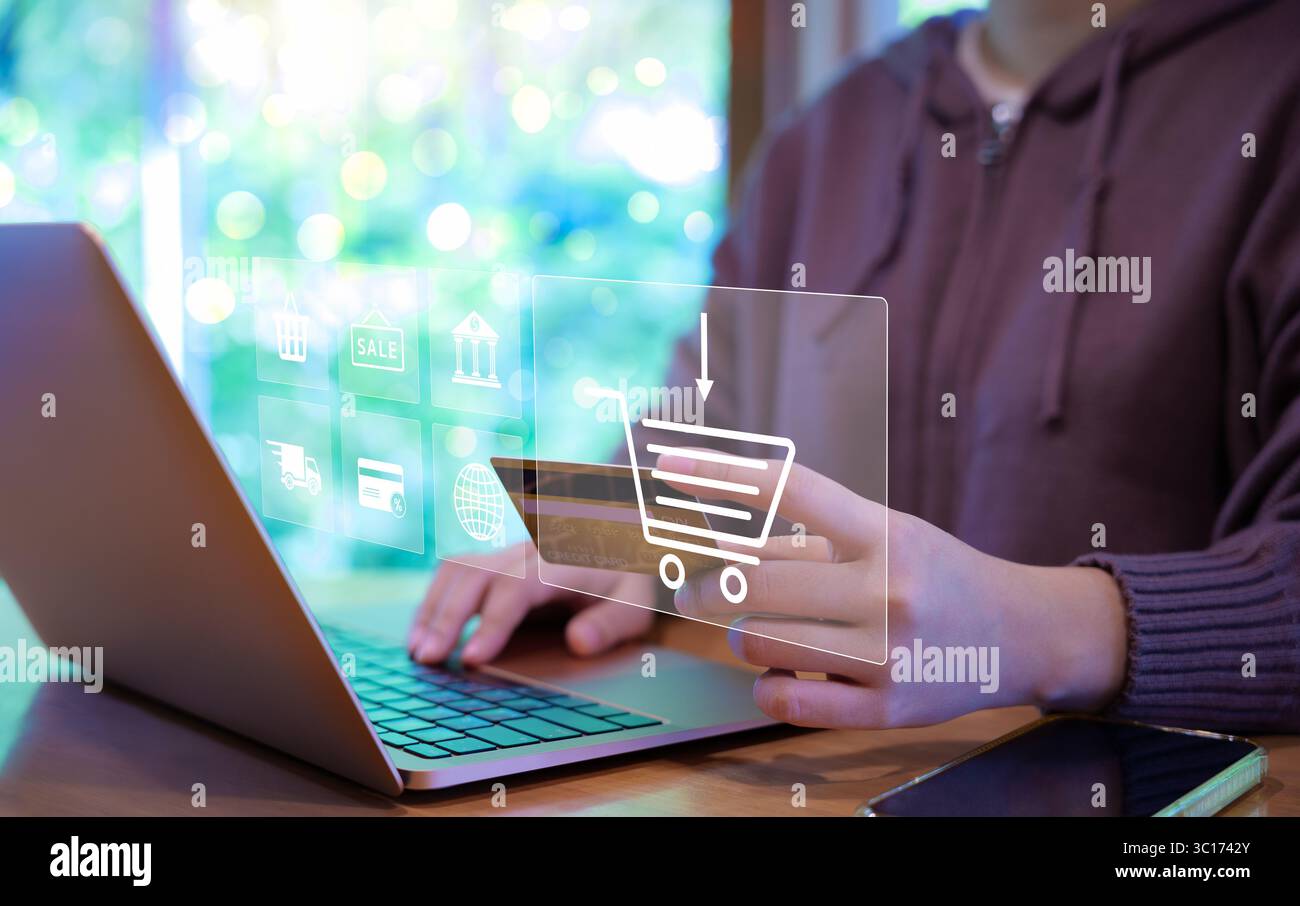 Frauen verwenden Laptop, um online mit Einkaufswagen und Business-Ikonen einzukaufen. Bestellung, digitales Marketingkonzept, Einzelhandel im Internet-Websit Stockfoto