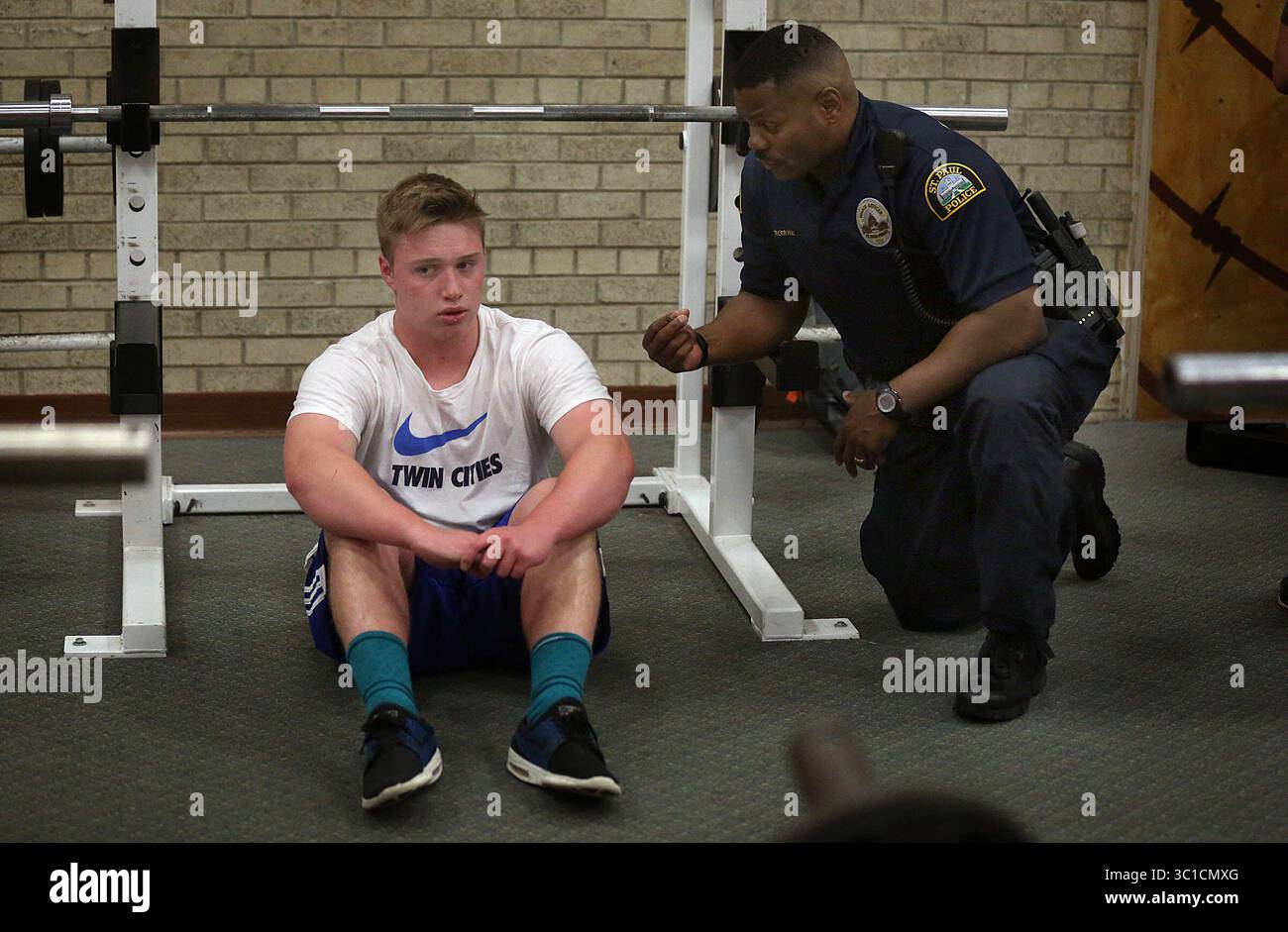 8. Juni 2016: St. Paul, MN, USA: Cortez Hull, Schulressourcenoffizier (SRO) an der Highland Park High School in St. Paul, sprach mit dem 15. Jährigen Peyton Haider über das Gewichtheben nach der Schule. / St. Paul, MN / 8. Juni 2016 15:00 Uhr – HINTERGRUNDINFORMATIONEN: Die jüngsten Ereignisse haben scharfe Kontraste in der Art und Weise gebracht, wie Schulverantwortliche -- Polizisten in den Schulen -- vor Ort gesehen werden, und ihre Zukunft in zwei der größten Bezirke des Bundesstaates ist eine Frage, die jetzt diskutiert wird. In St. Paul ehrten die Bezirksführer Vernon Simmons, einen langjährigen SRO, der für seine beruhigende Präsenz an der Johnson High bekannt ist, bei einem Treffen o Stockfoto