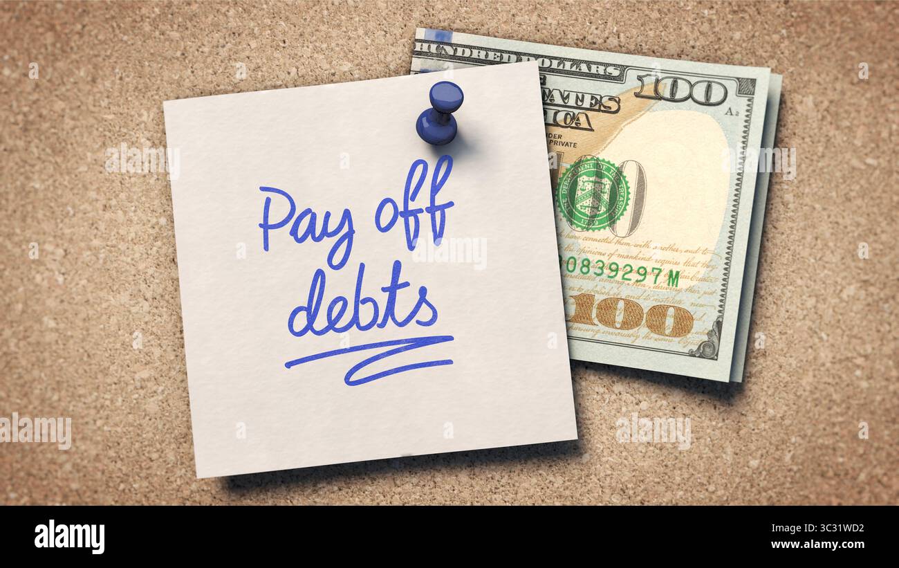 Schulden auszahlen – Eine Haftnotiz mit „Schulden auszahlen“ in blauer Tinte ist an eine Korkwand mit einer blauen Stecknadel geheftet Stockfoto