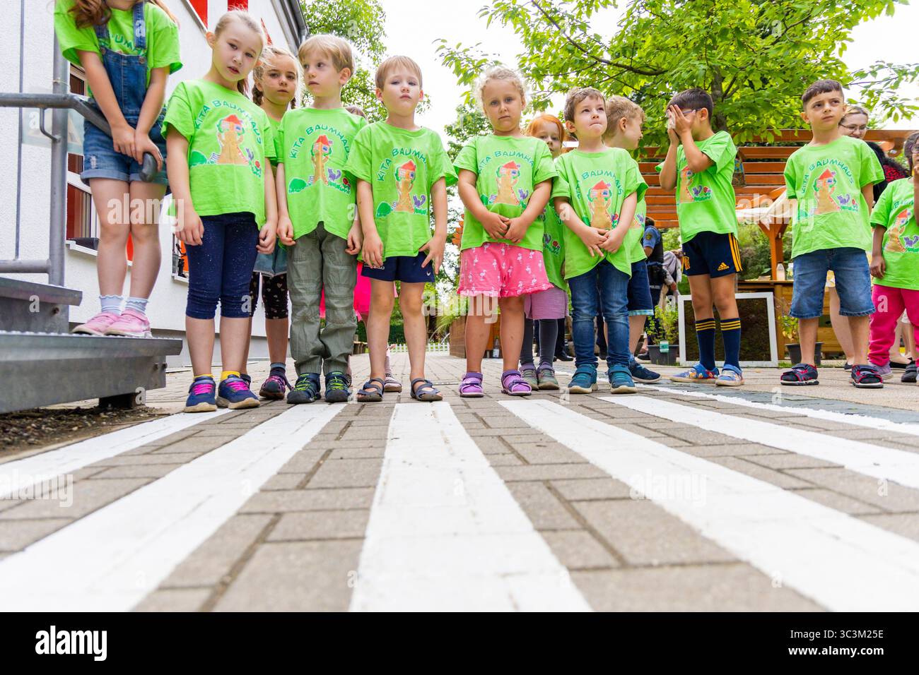 Presse- und Fototermin zur Verkehrssicherheit in der Kita Baumhaus die Dresdner Kita BAUMHAUS mit ihrem naturpädagogischen Schwerpunkt. Die gute Verkehrsanbindung birgt aber zum Teil komplexe Herausforderungen für die künftigen Schulkinder. Durch gezielte Übungen, Rollenspiele und gemeinsame Spaziergänge mit ihren Erzieherinnen und Erziehern können die Kinder ein Gefühl für sichere Verhaltensweisen im Straßenraum entwickeln. Einmal im Jahr bringen Bürgerpolizisten den Vorschulkindern die wichtigsten Verkehrsregeln auf spielerische Weise näher. Die Kinder wurden sensibilisiert, Gefahren m Stockfoto