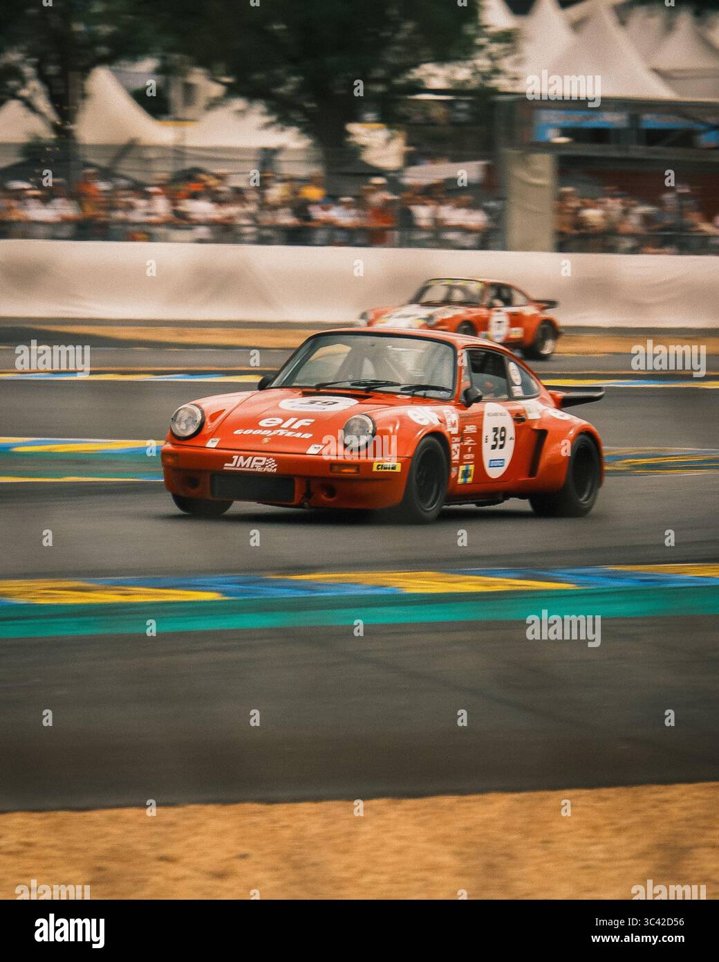 Le Mans, Frankreich - 07. Juni 2025: Blick auf Porsche-Oldtimer, die auf dem Circuit des 24 Heures du Mans rasen, mit leuchtendem orangefarbenem Farbkontrast Stockfoto
