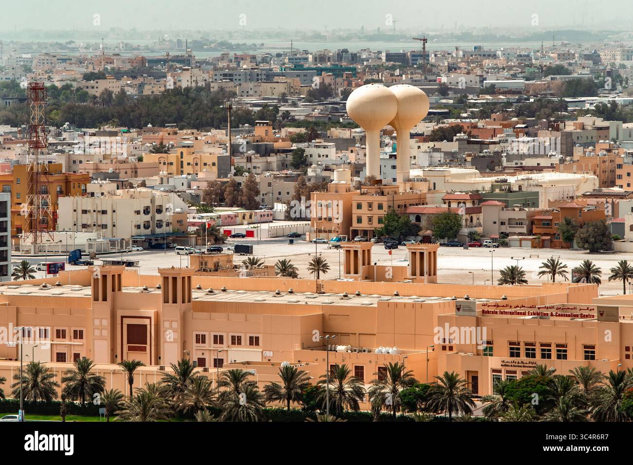 Das beigefarbene Bahrain International Exhibition & Convention Centre und die zwei Wassertürme stehen aus der Vogelperspektive von Manama, Hauptstadt Stockfoto