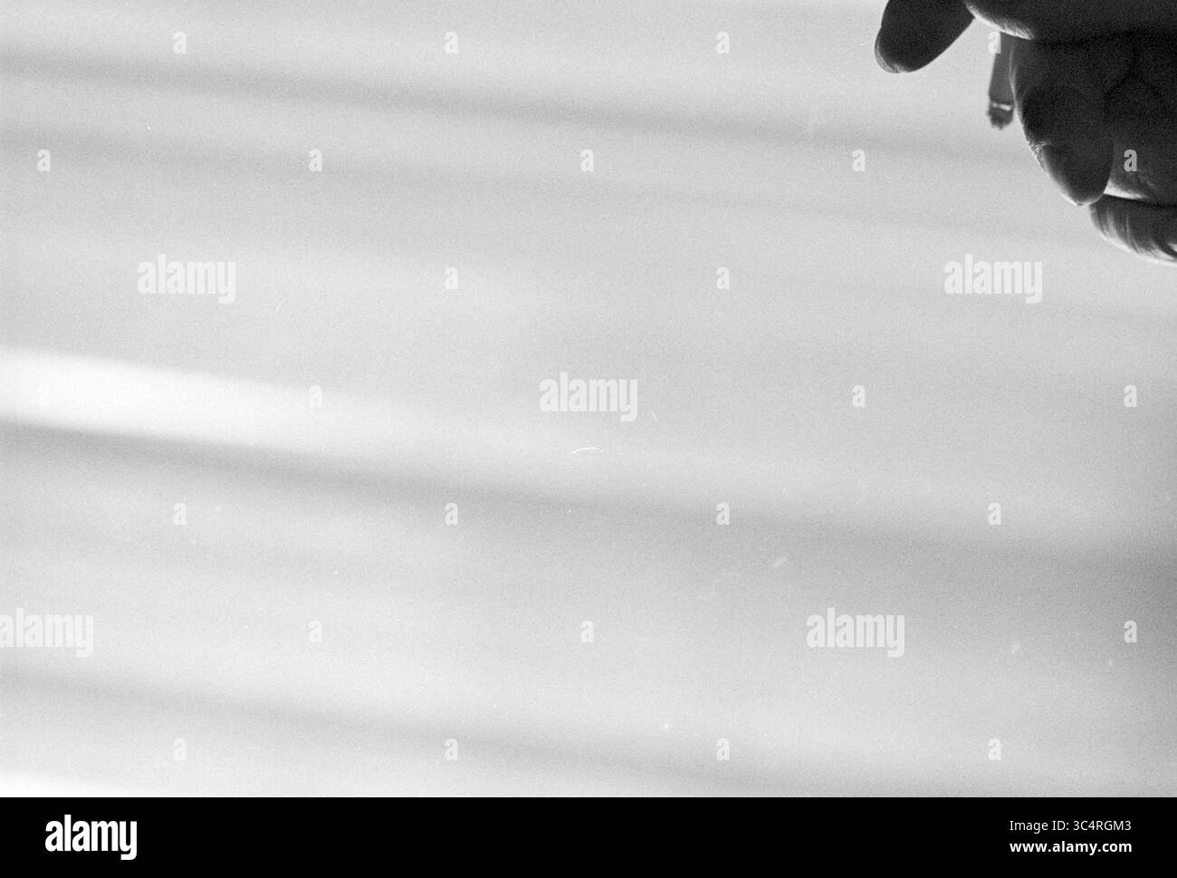 Porträt älterer Mann Whizgle News, Dutch Desk, Niederlande, 1950-2000 Eine Hand streckt sanft nach außen, die Finger leicht ausgestreckt, vor einem sanft verschwommenen Hintergrund, der Licht und Bewegung suggeriert. Stockfoto