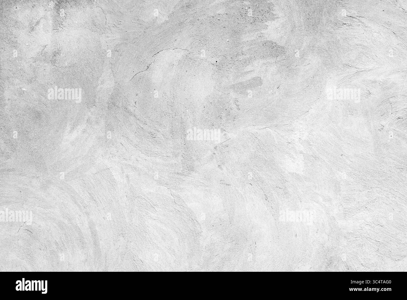 Eine detaillierte Ansicht einer weißen strukturierten Betonoberfläche mit weichen, wirbelnden Mustern, ideal für den Einsatz als Hintergrund oder Designelement, die ne betonen Stockfoto