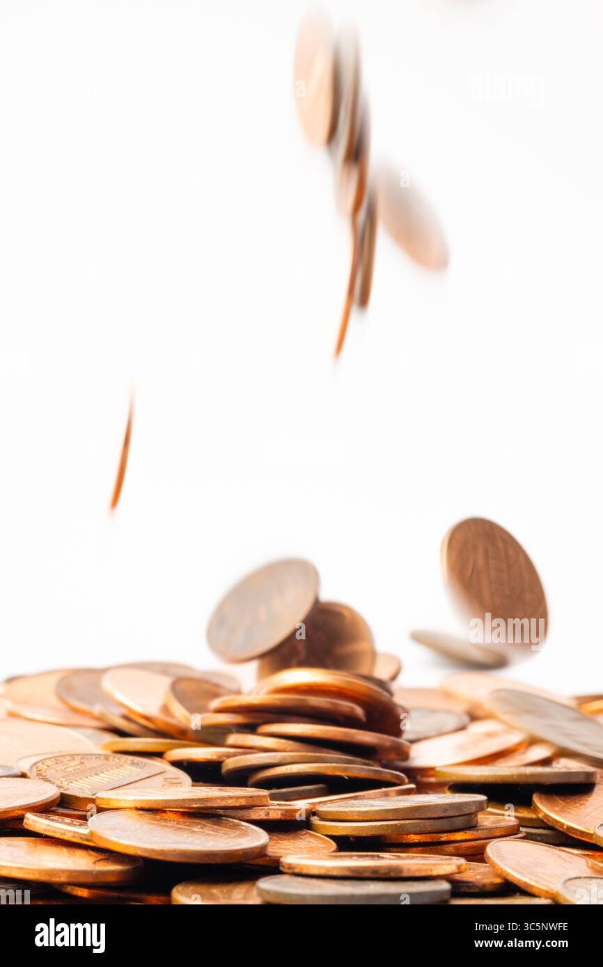 Pennys in Bewegung fallen in einen Haufen Stockfoto