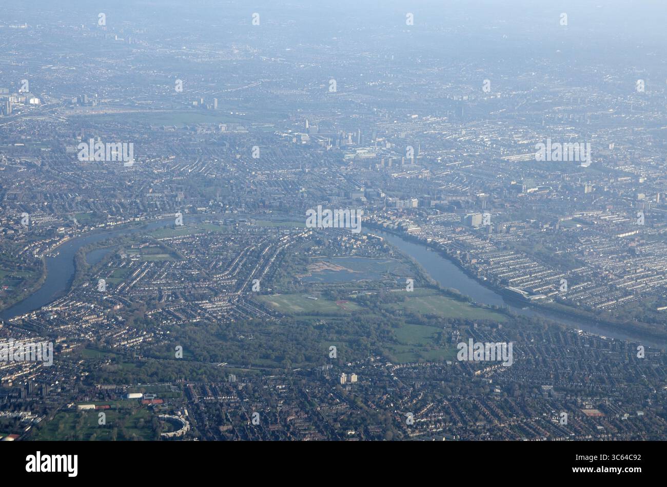 Aus der Vogelperspektive auf die Krümmung der Themse bei Barnes mit Hammersmith und Fulham über dem Fluss. Sonniger Frühlingsmorgen. Stockfoto