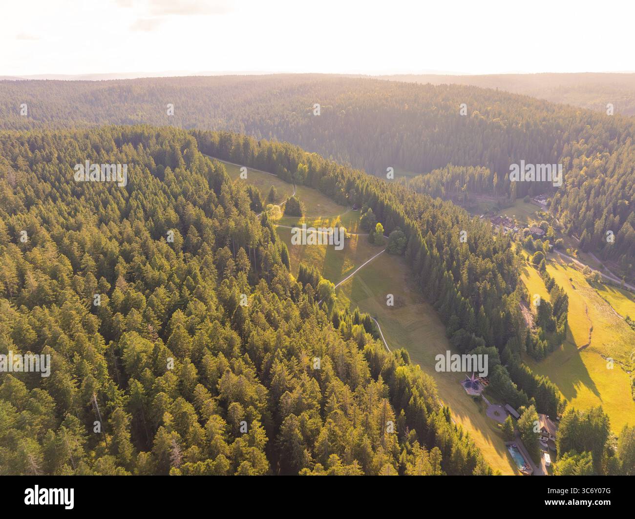Umfassender Blick über bewaldete Hügel und Täler in der Ferne, bei warmem Abendlicht, Retro Freizeitpark Poppeltal Riesenrutschbahn, Enzkloesterle Stockfoto