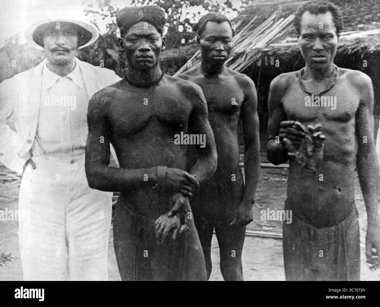 Ein Missionar mit kongolesischen Männern, die die amputierten Hände von zwei Männern (Lingomo und Bolenge) zeigen, die von freien staatlichen Truppen getötet wurden, die als Gummiwächter der Demokratischen Republik Kongo (ABIR) (Anglo-Belgian India Rubber Company) eingesetzt wurden Foto von Alice Seeley Harris und ihrem Ehemann John Harris, aufgenommen 1904 und verwendet, um den Fall Roger Casement zu unterstützen. Stockfoto