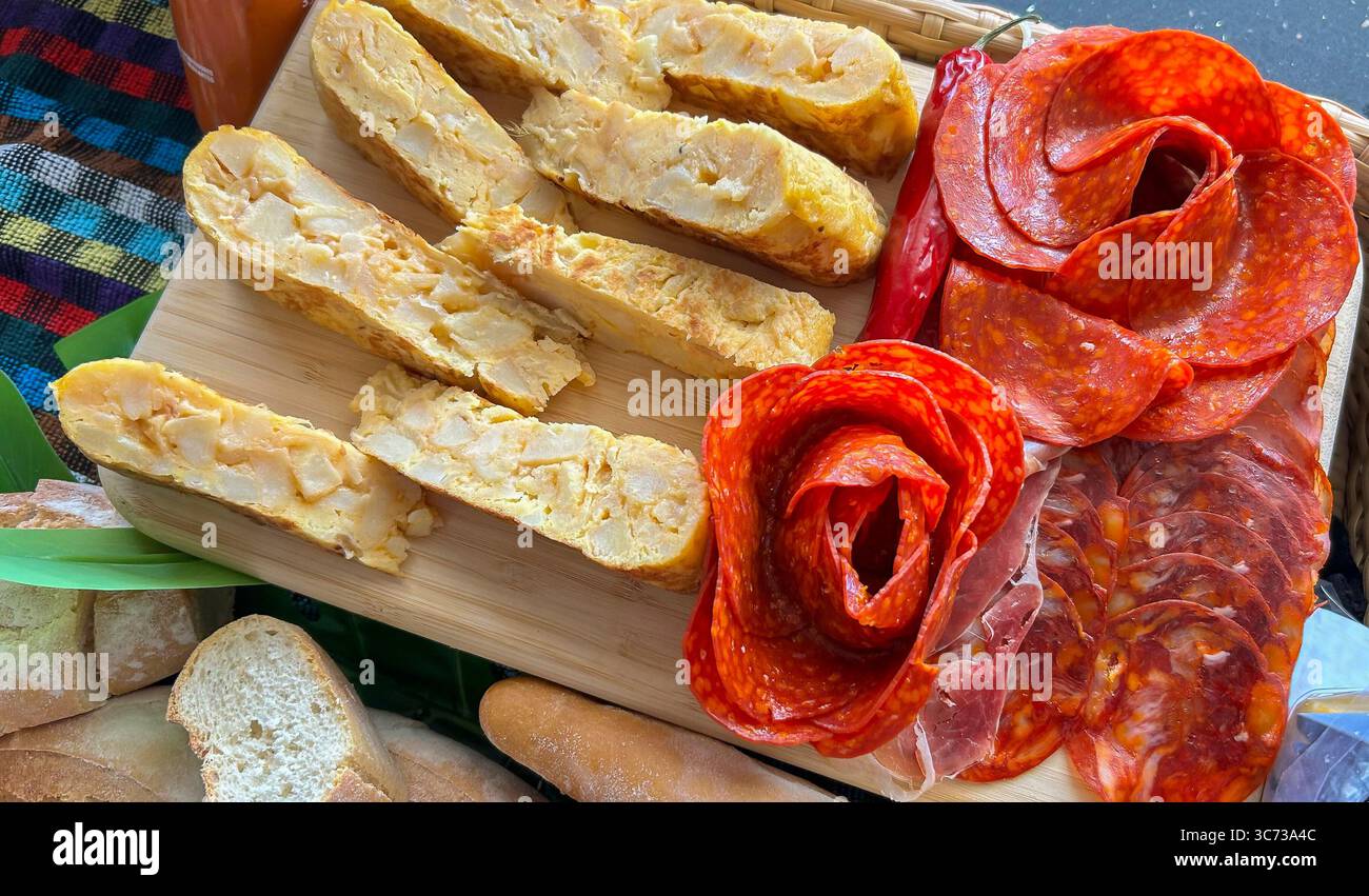 Kochbrett mit Räucherfleisch und spanischem Kartoffelomelett Stockfoto