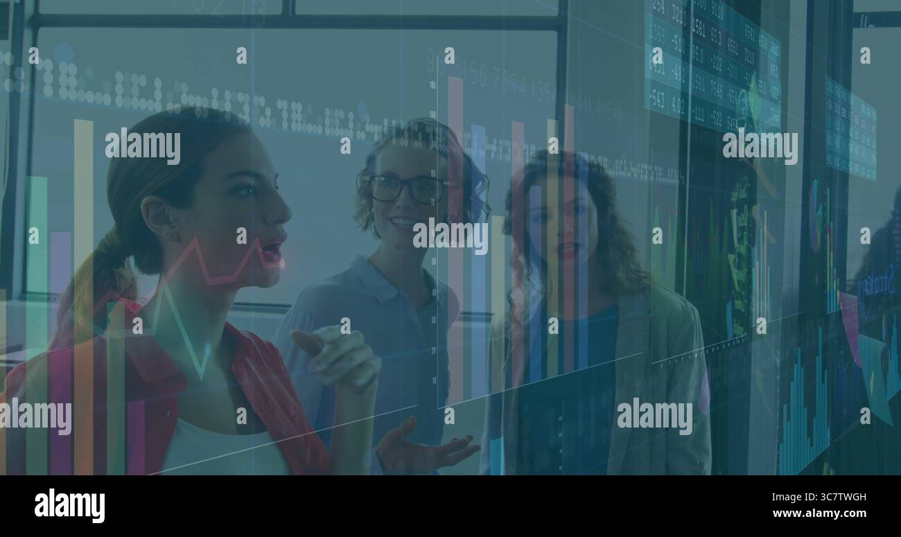 Drei Geschäftsfrauen zeigen auf digitale Karten an der Glaswand im Besprechungsraum mit Datenprojektionen Stockfoto