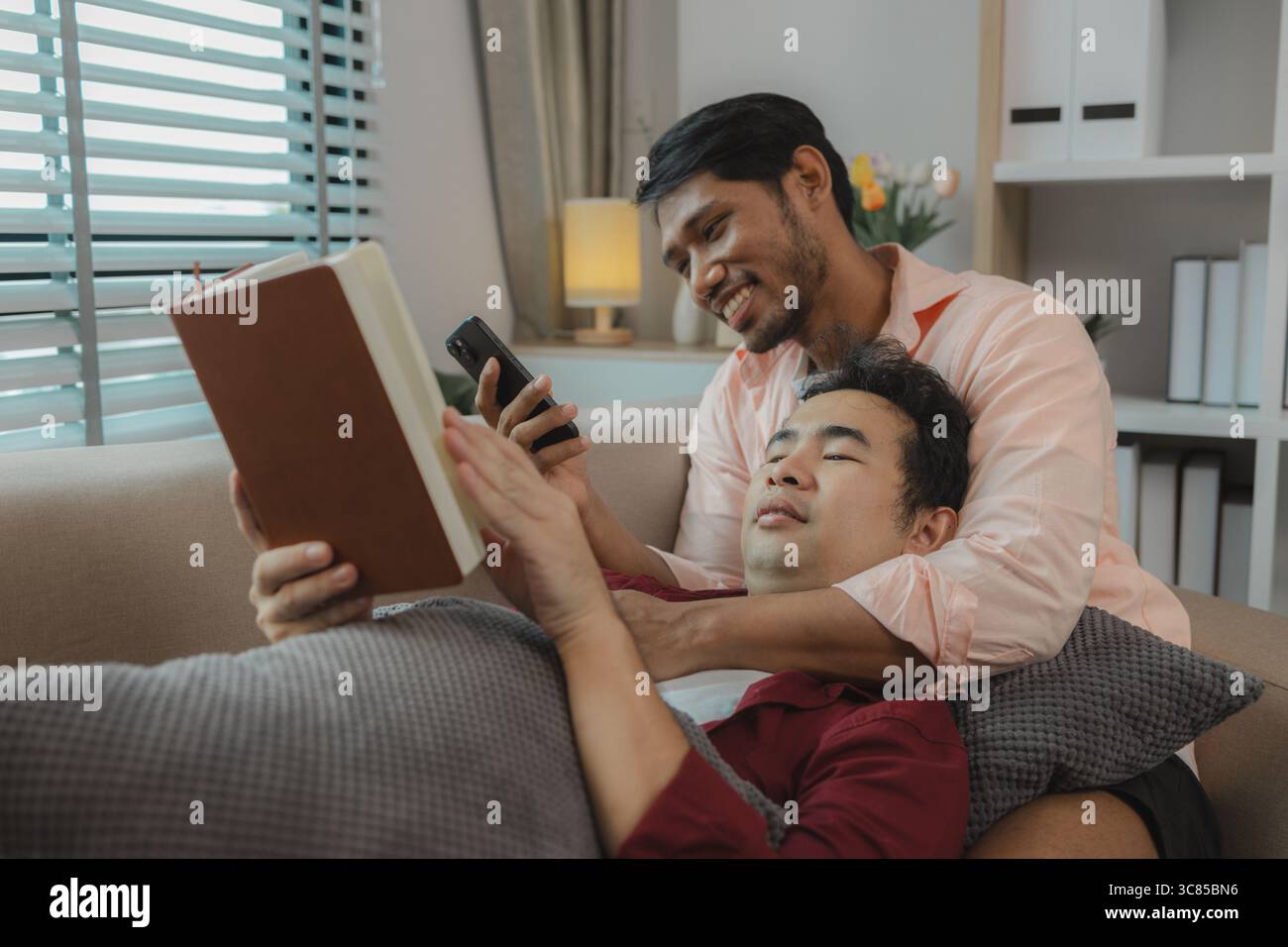 Zwei gutaussehende Jungs haben eine schöne Freundschaft für lange Zeit, die beiden Liebenden drücken ihre Liebe zueinander sehr süß aus, dieses männliche Paar sieht aus Stockfoto