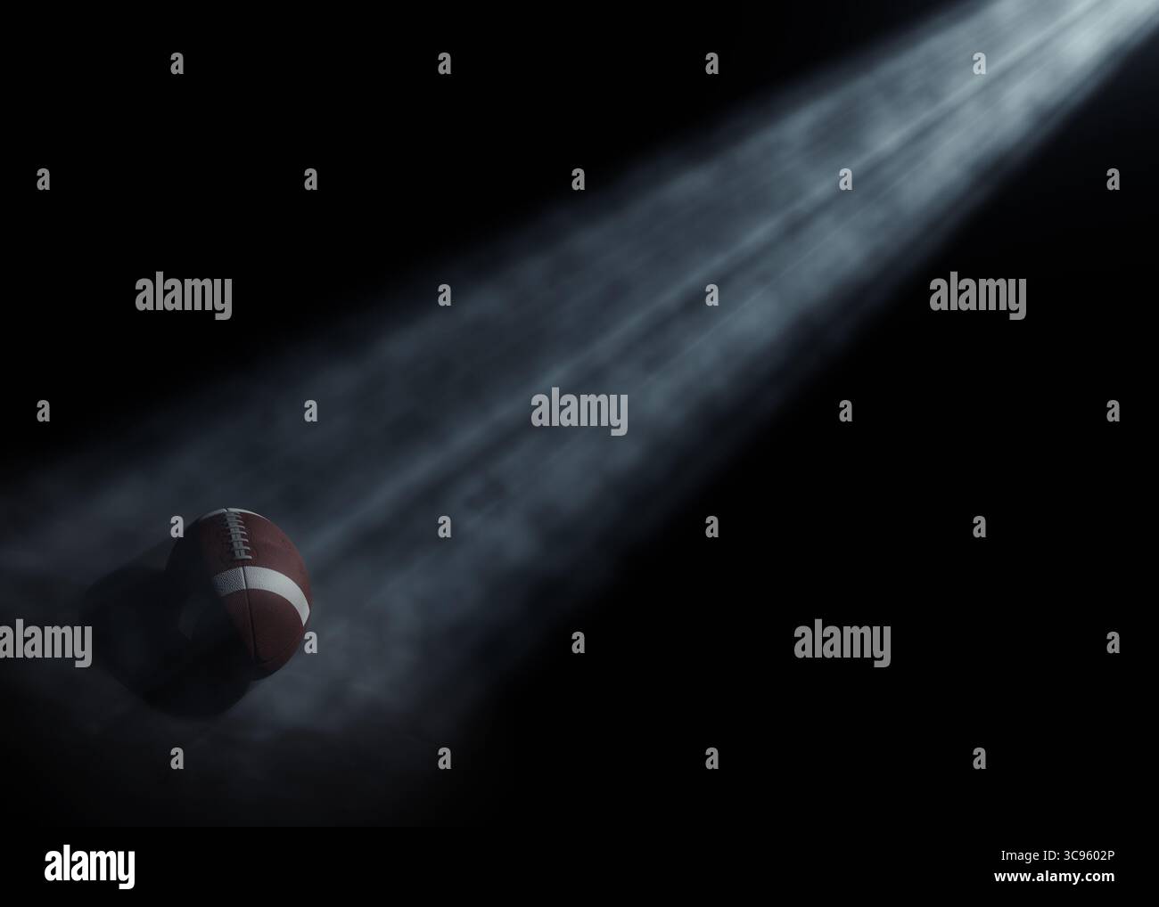 Ein american Football-Sportball, der von einem einzigen ätherischen Licht auf einem dunkelschwarzen Hintergrund beleuchtet wird – 3D-Rendering Stockfoto