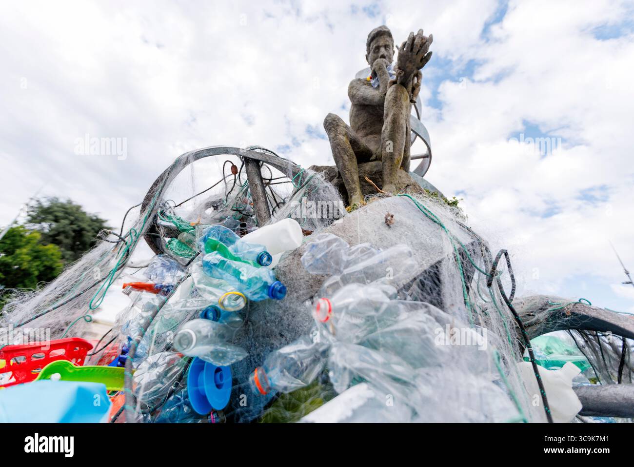Der Umweltkünstler Benjamin von Wong und seine Installation „The Thinker's Burde“ vor dem Hauptquartier der Vereinten Nationen in Genf. Die Installation wurde in Zusammenarbeit mit der Minderoo Foundation, SLS Illusions und mit der Hilfe von einem Dutzend Freiwilligen durchgeführt. Während der Verhandlungswoche um den Global Plastic Treaty wird die Skulptur langsam in Plastikmüll verwickelt sein. Quelle: Orjan Ellingvag/Alamy Live News Stockfoto