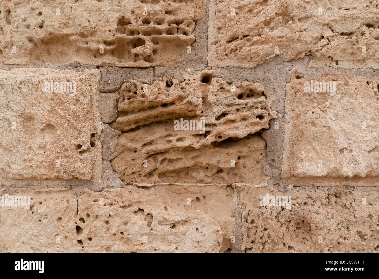 Nahaufnahme der verwitterten Kalksteinmauer mit natürlicher Textur und historischem Charakter, Nordzypern Stockfoto