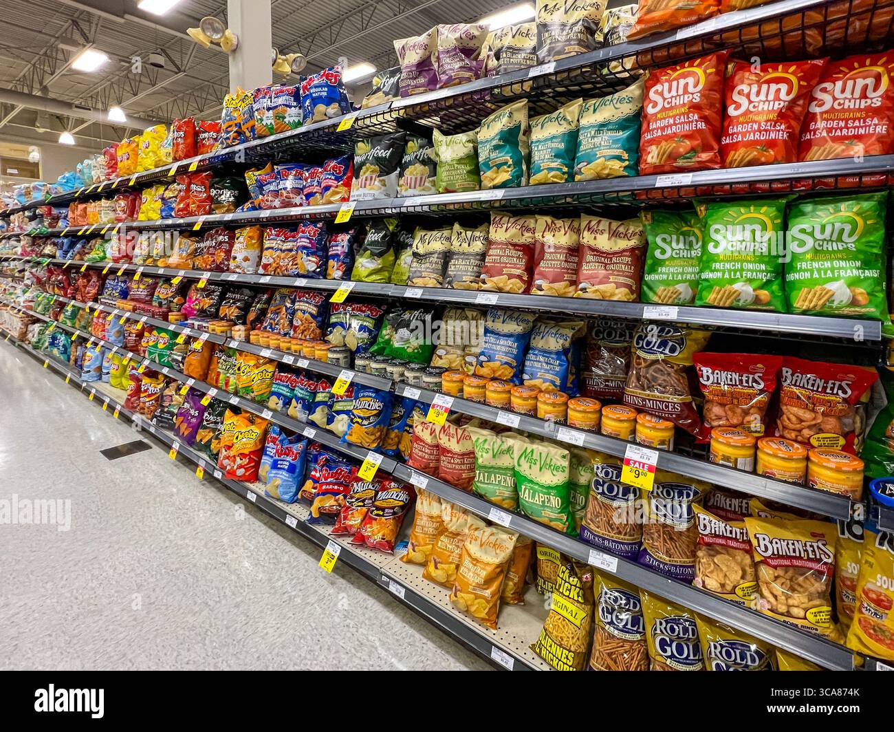 In den Regalen gibt es eine Auswahl an Chips und Snacks, die in einem Supermarkt verkauft werden. Alberta, Kanada. Stockfoto