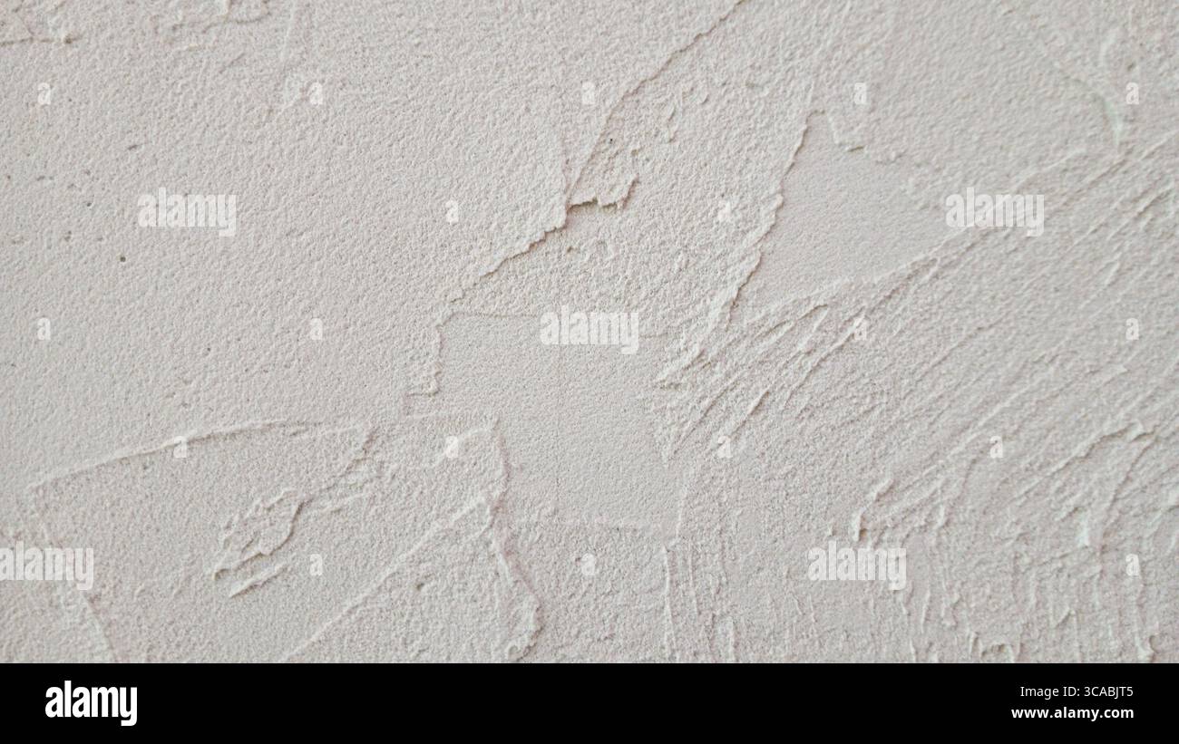 Nahaufnahme einer rauen strukturierten Putzwand in neutralem Beige-Ton Stockfoto