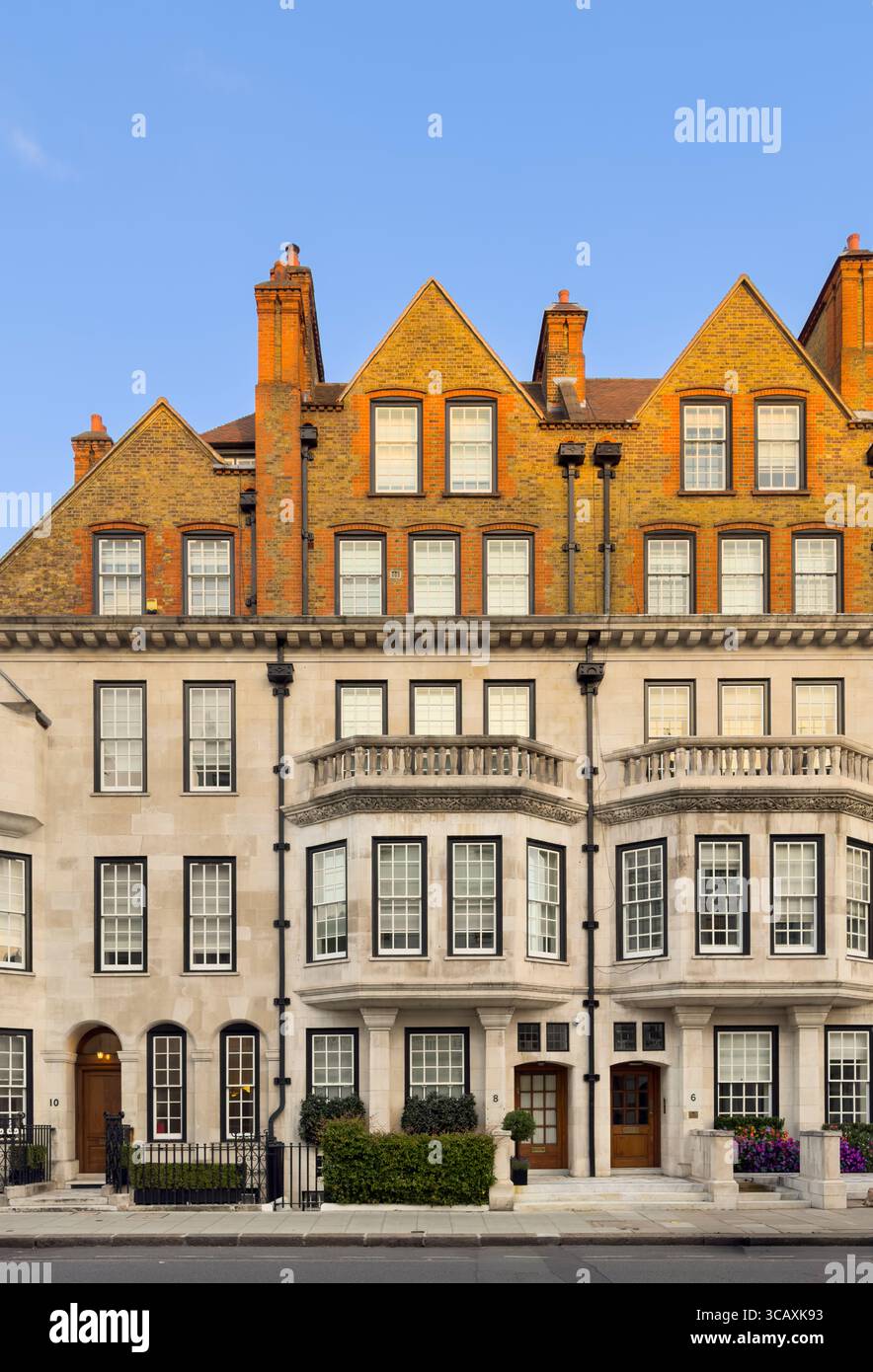 Die elegante Fassade historischer Stadthäuser aus Backstein und Stein, typisch für die wohlhabende Wohnarchitektur im Zentrum von London, Großbritannien. Stockfoto