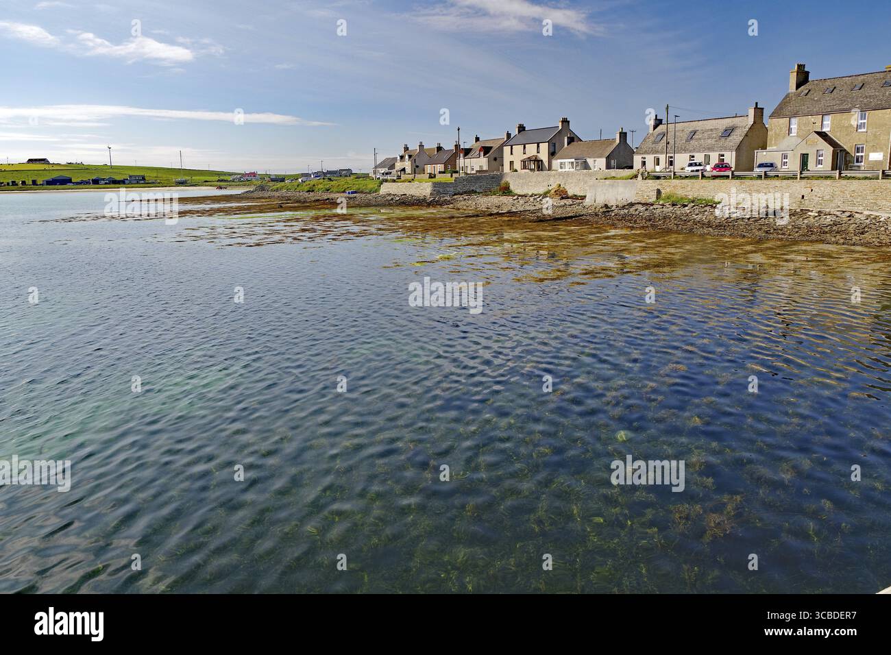 Ruhiges Küstendorf mit Häusern am Wasser und blauem Himmel im Hintergrund Stockfoto