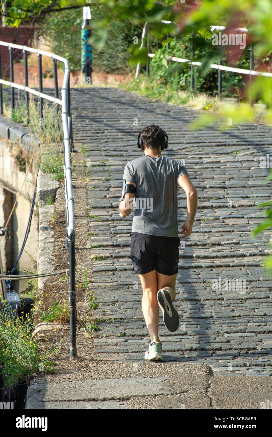 London, England, Großbritannien, 8. August 2025. Männlicher Jogger macht einen entspannten Lauf entlang des Lea Valley Kanals im Norden Londons vor der vorhergesagten viertägigen Hitzewelle im August. Die Temperaturen werden voraussichtlich über 30 °C in London und im Südosten vom 11. Bis 15. August erreichen. Quelle: Flavia Brilli/Alamy Live News Stockfoto