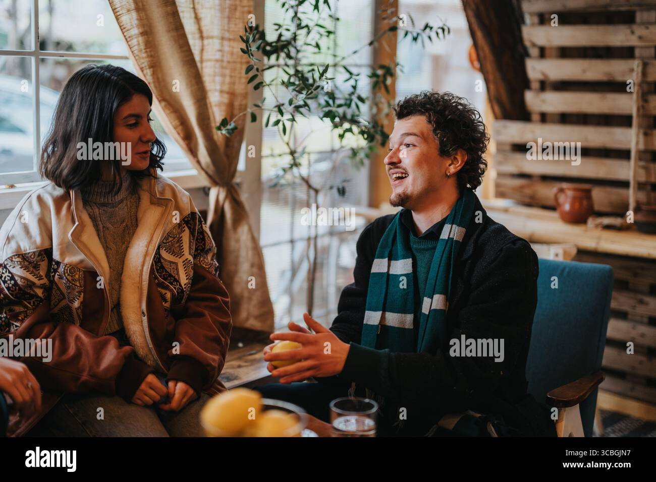 Zwei Freunde, die sich in einem gemütlichen Café unterhalten Stockfoto
