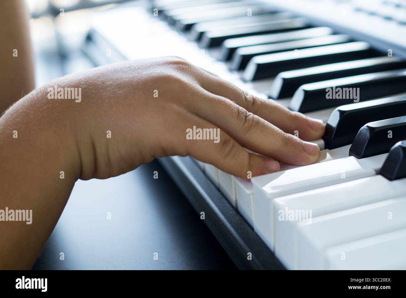 Der Schüler spielt Klavier mit seinem Lehrer Stockfoto