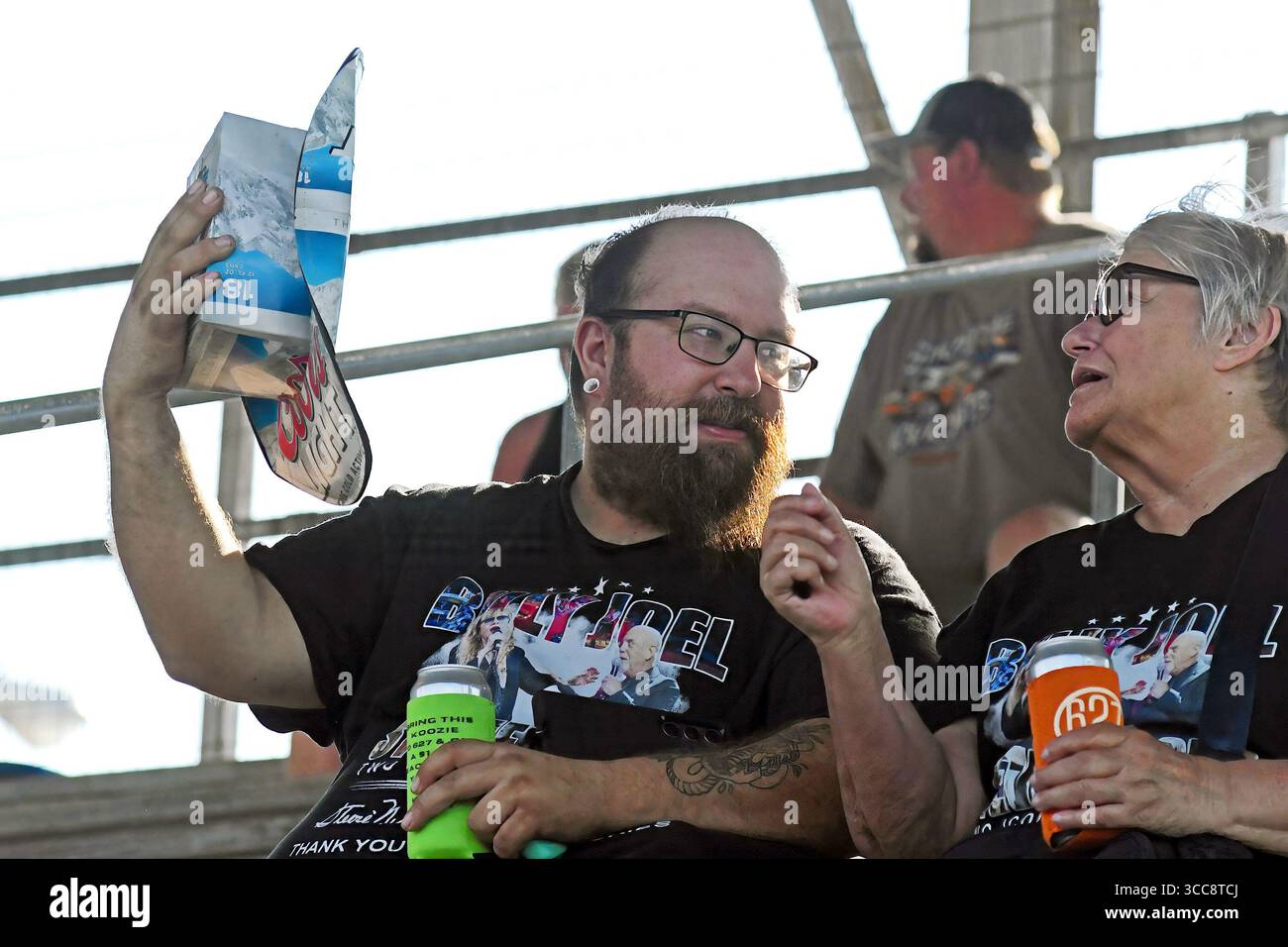 EMPORIA KANSAS, USA - 9. AUGUST 2025 Mann zeigt seinen Hut aus Pappbierkarton beim Demolition Derby, der die jährliche Lyon County Messe beendet, die eine große Menge von über tausend Fans anzog Stockfoto