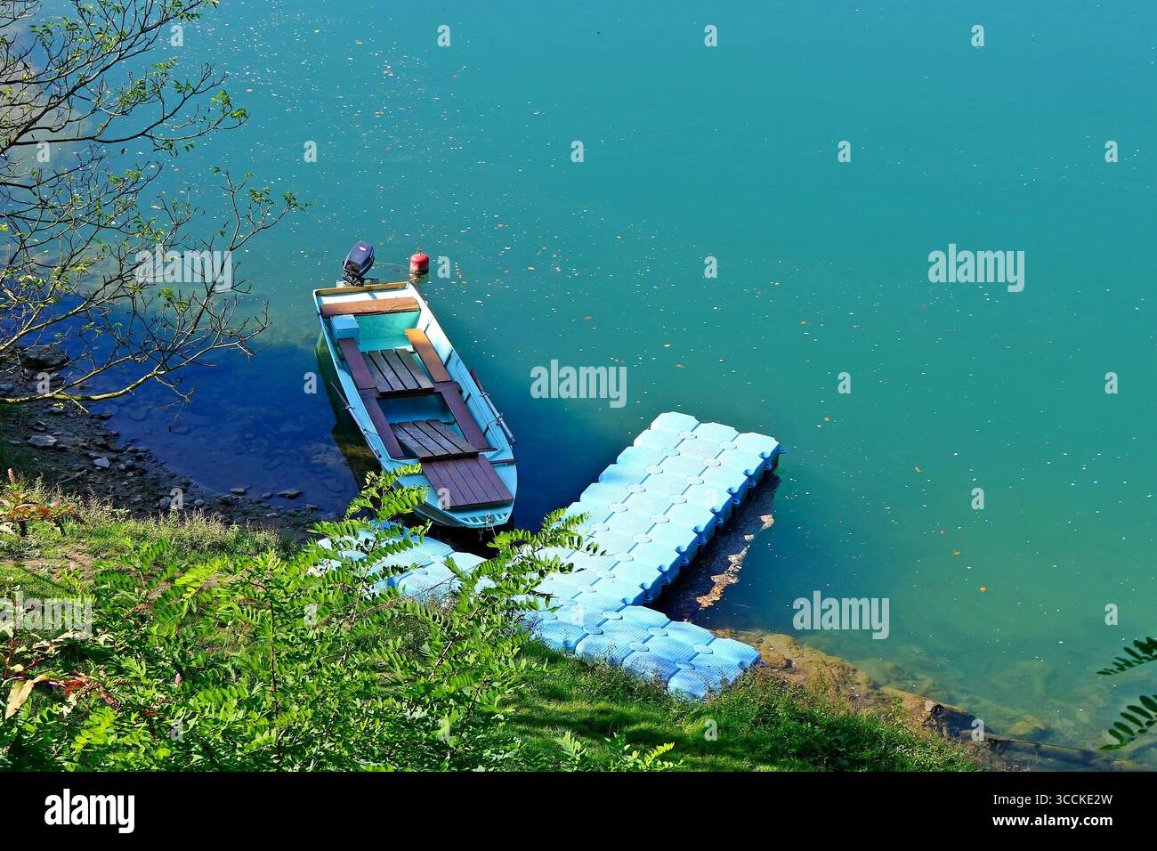 Ein Motorboot an einem schwimmenden Plastikponton für eine romantische Fahrt entlang des ruhigen grünen Wassers des Drina River, der Perle Serbiens Stockfoto